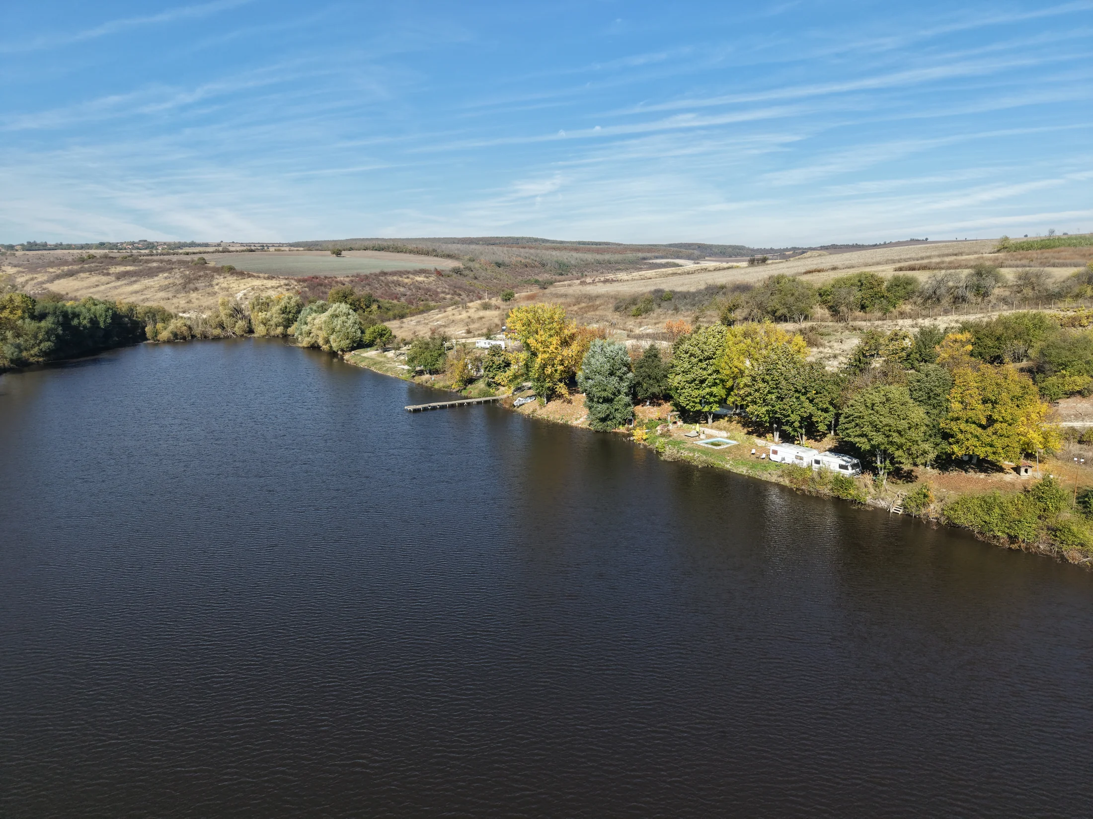 Aerial view over the lake and wooded shoreline at Razvigorovo