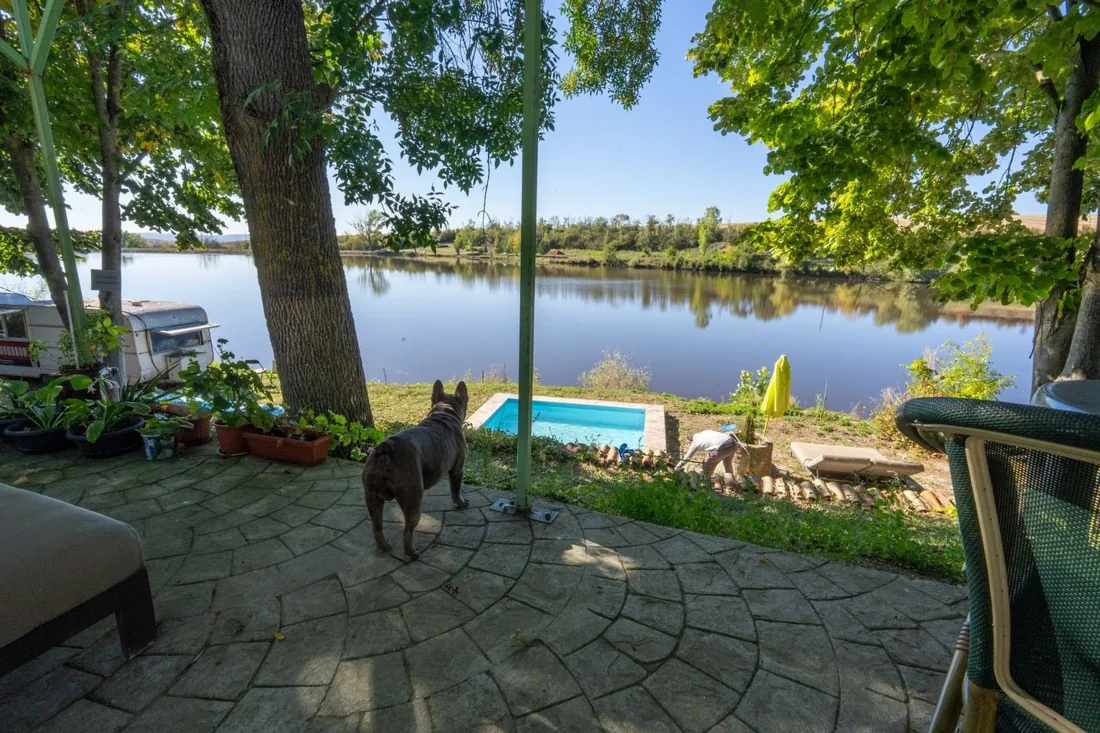 Terrace, pool and seating overlooking the lake